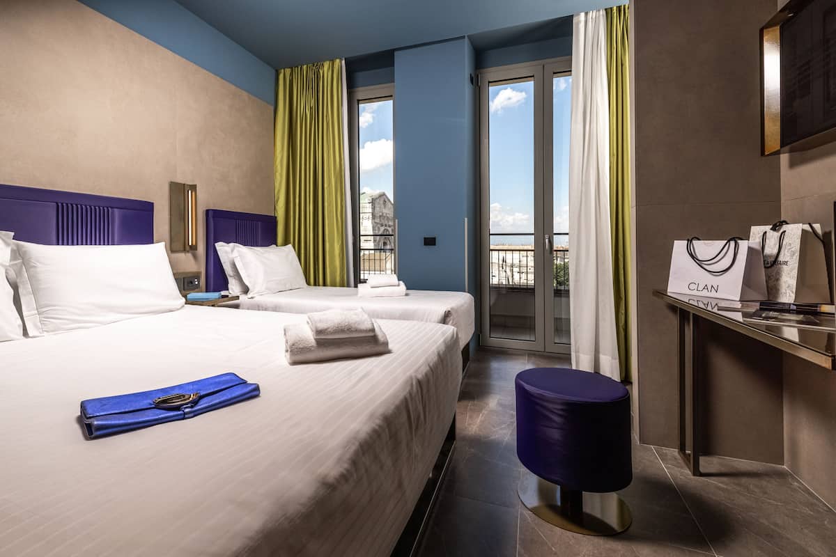 Driepersoonskamer, balkon, uitzicht op stad | Donzen dekbedden, een minibar, een kluis op de kamer, een bureau
