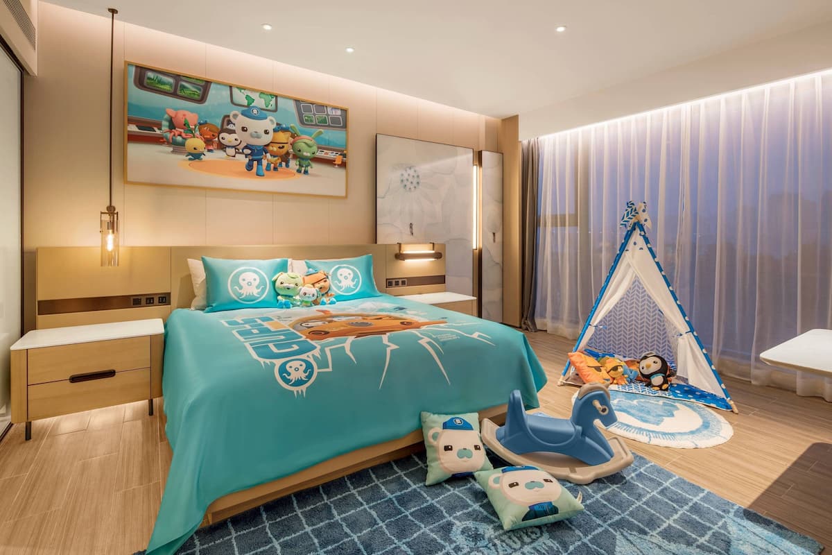 A child's bedroom with a bed, a tent, and various toys.