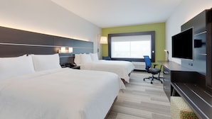 A hotel room with two beds, a desk with a chair, a flat-screen TV, and a window with a city view. - Holiday Inn Express Kermit by IHG (Kermit)