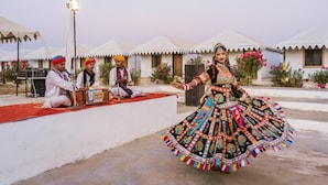 A traditional dance performance in front of a row of white tents with a red carpet. - Style Desert Camp Jaisalmer (Jaisalmer)
