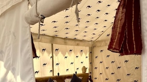 A tented room with a bed, pillows, and a patterned blanket. - Style Desert Camp Jaisalmer (Jaisalmer)