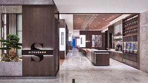 A modern kitchen area with a central island, built-in appliances, and a bar area with refrigerated shelves. - Sheraton Shanghai Fengxian (Shanghai)
