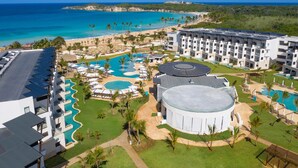 A resort with multiple swimming pools, a beach, and a view of the ocean. - Dreams Macao Beach Punta Cana - All Inclusive (Punta Cana)
