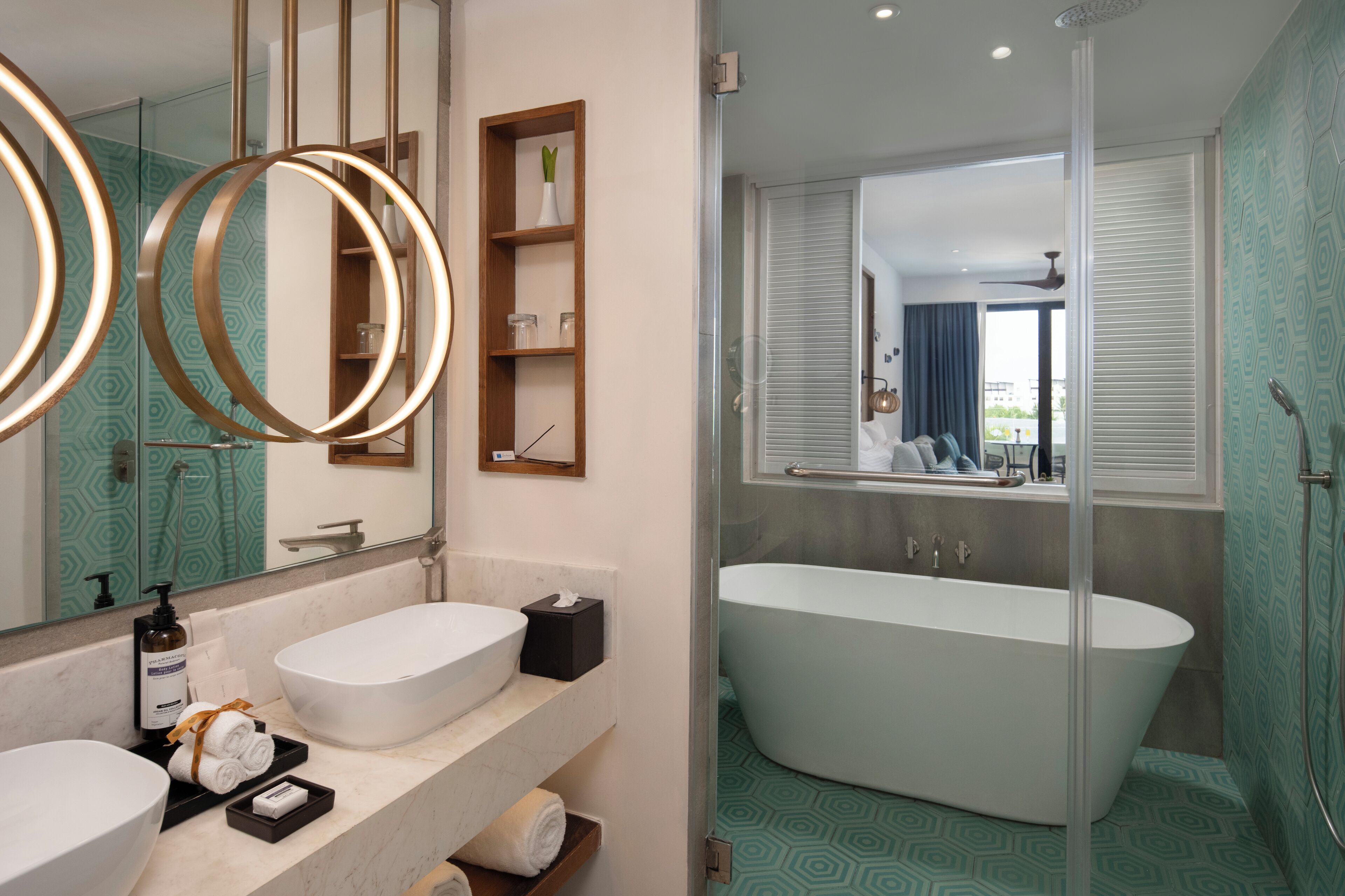 A modern bathroom with two sinks, a freestanding bathtub, and a glass-enclosed shower area.