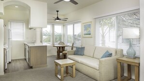 A compact living space with a kitchenette, a dining area, and a seating area with a sofa and a small table. - WCH at Wave Crest Resort (Del Mar)