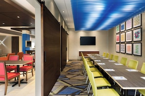 A conference room with a long table, yellow chairs, and a patterned carpet. - Holiday Inn Express & Suites Warsaw - E Center by IHG (Warsaw)