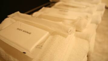 A row of neatly folded towels with the text "BODY SPONGE" on them.