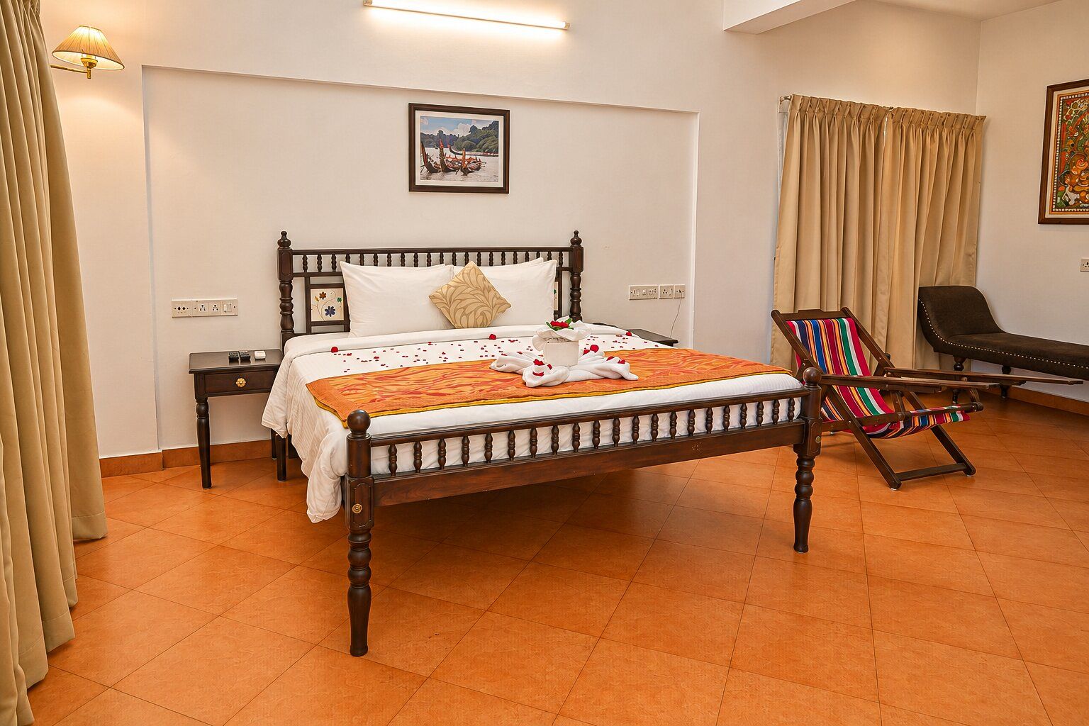 A hotel room with a wooden bed, a bedside table, a chair, and a picture on the wall.