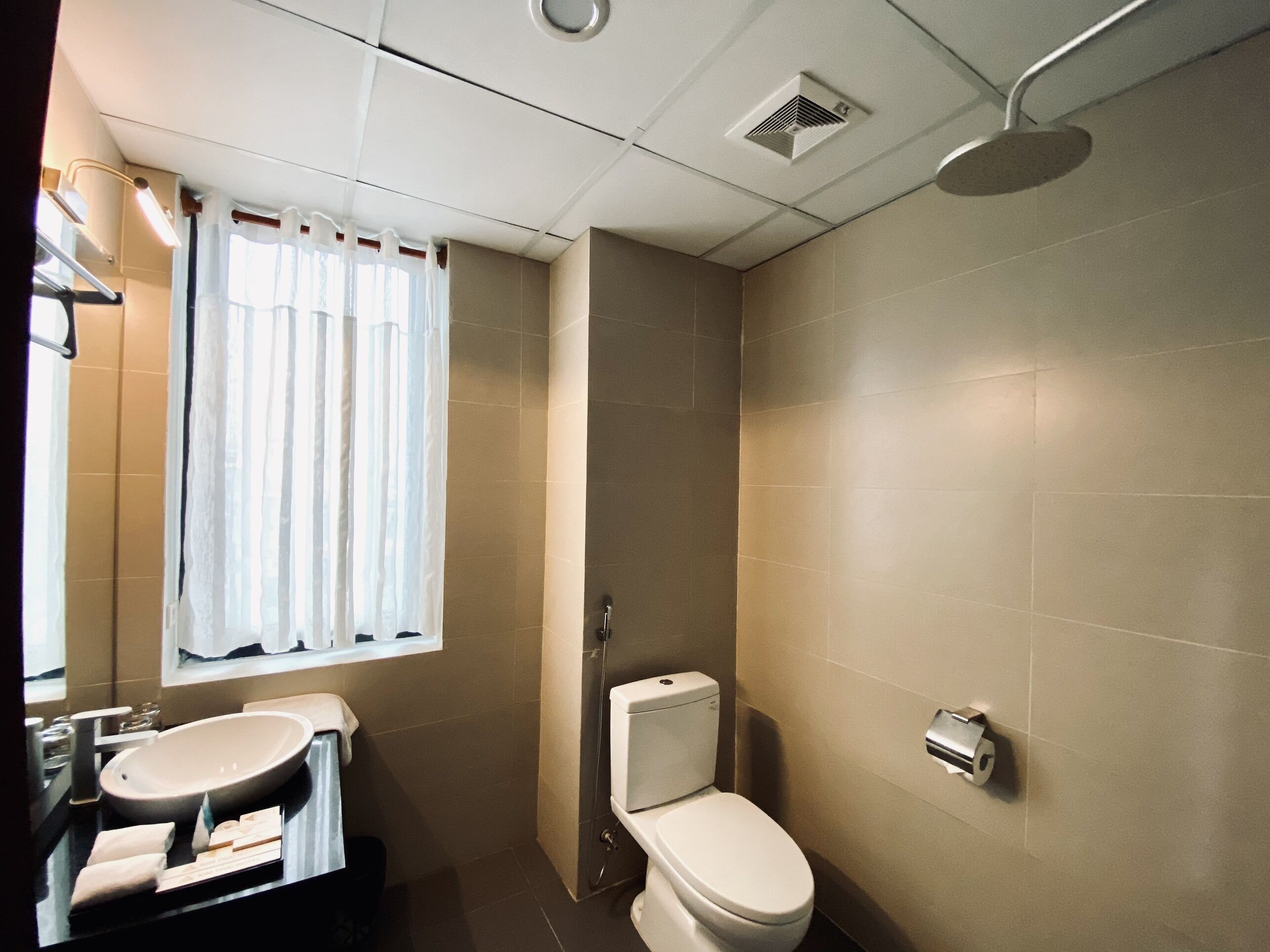 A bathroom with a sink, toilet, and shower.