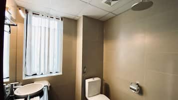 A bathroom with a sink, toilet, and shower.