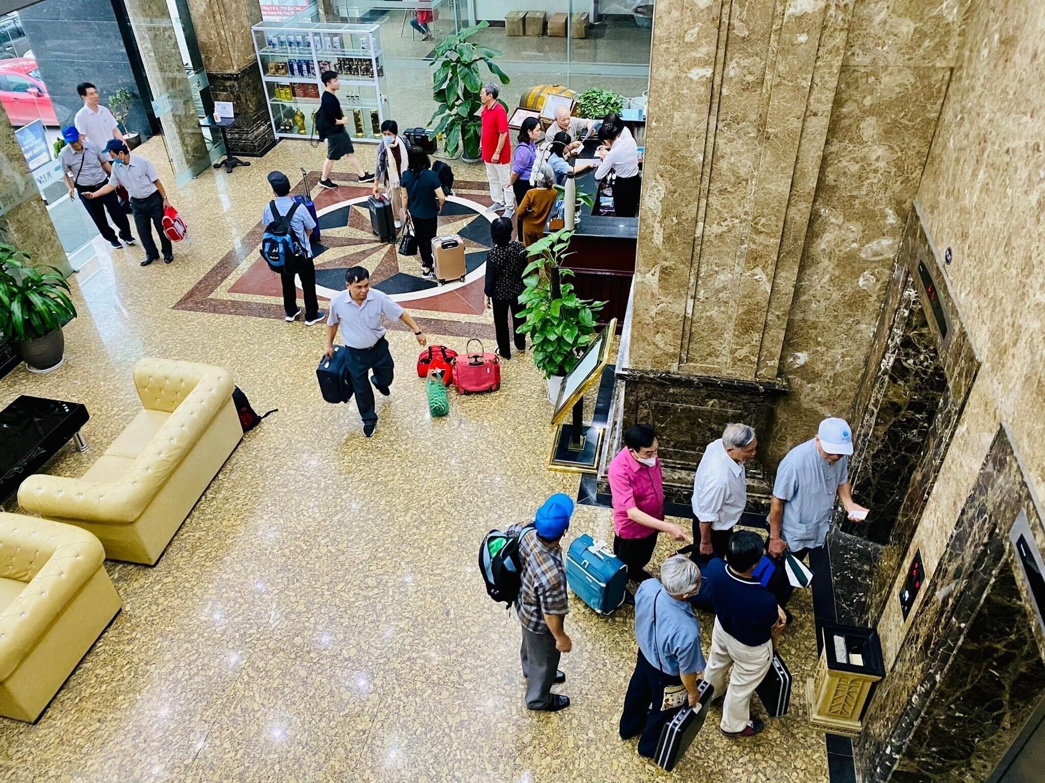 A lobby with a marble floor, a seating area, and a reception desk.