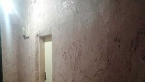 A narrow hallway with textured walls and patterned floor tiles. - Youth guest house (Wadi Musa)