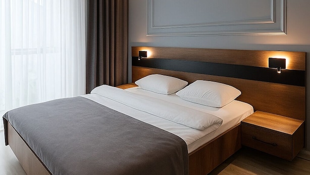 A modern hotel room with a large bed, wooden headboard, bedside tables, and a large window with curtains. - On4 Rooms & Suites (Istanbul)