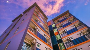 A multi-story building with balconies and air conditioning units. - Thawan Apartment (Satun)