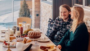 A breakfast setting with a table set for two, featuring a variety of foods and drinks. - Hotel Walliserstube (Damüls)