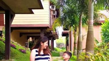 Stroll along the winding stone pathway to a serene building with a flat roof and balcony.