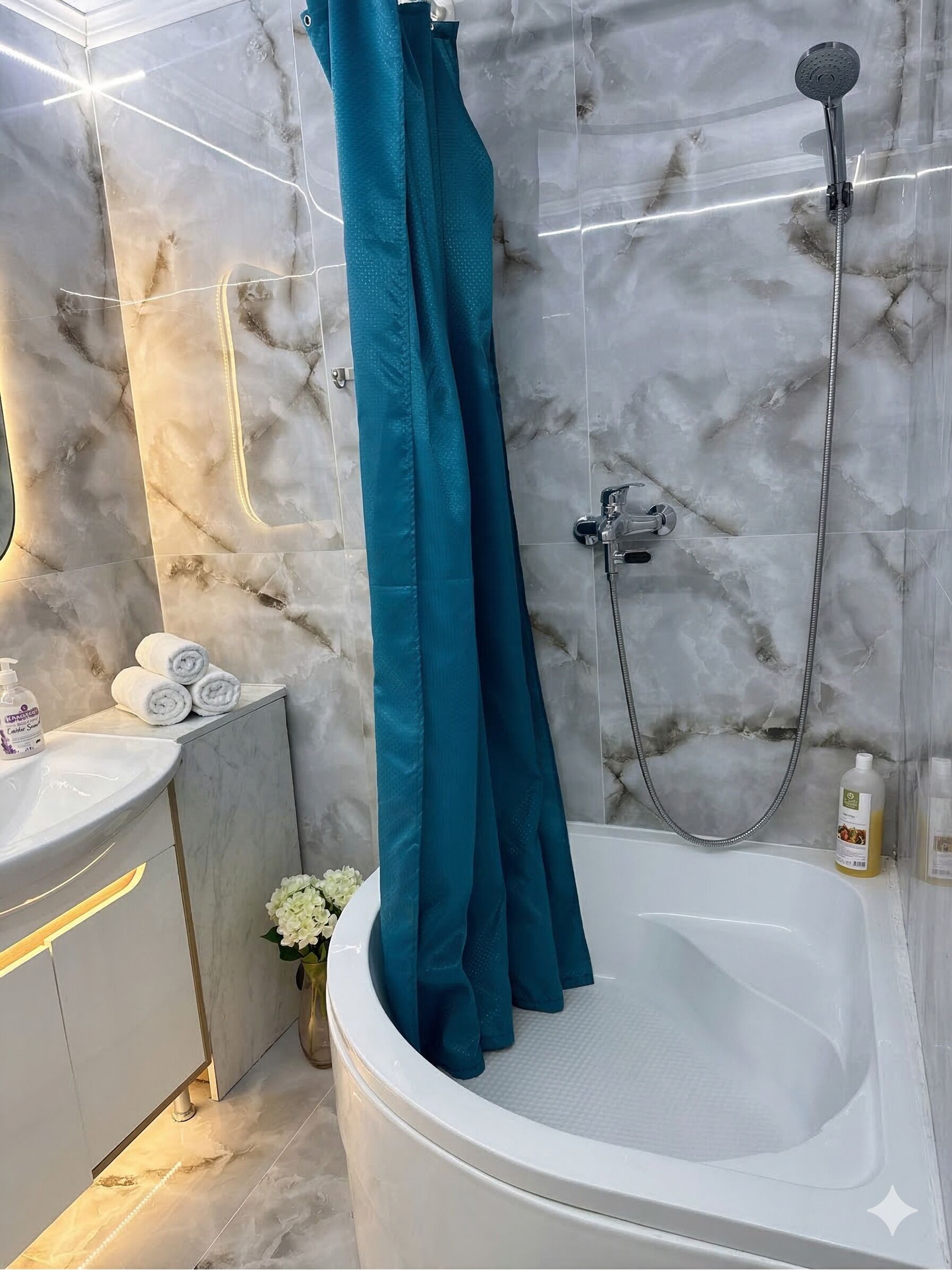 Ein Badezimmer mit einer Badewanne, einer Dusche, einem Waschbecken und einem Spiegel.