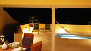 A covered outdoor area with a pool, chairs, and a hammock. - 2 Westlook (Gibbes)