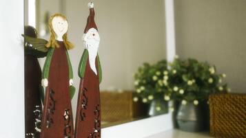 A decorative figure with a green hat and a white beard, standing next to a figure with a green dress and wings.