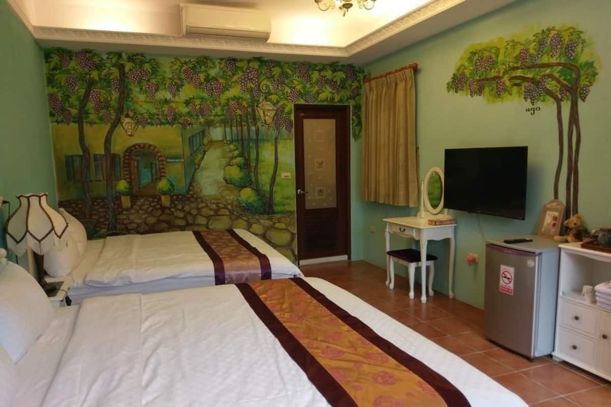 Une chambre d’hôtel avec deux lits, une télévision, un bureau et un mini-bar.