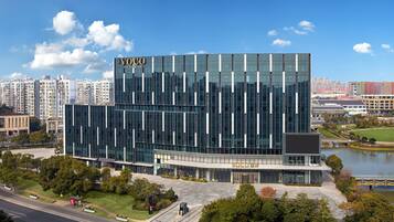 A modern building with a glass facade and a sign that reads "Voco".