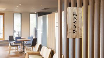 A modern interior with wooden partitions, a reception desk, and seating area.