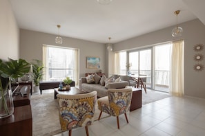 Relax in this stylish living room with a sofa set, armchairs, and a coffee table.