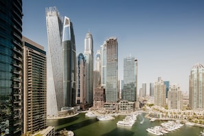 Overlooking a bustling marina, this property offers stunning views of the city skyline.