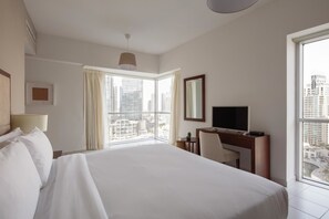 Enjoy a city view from the comfort of a spacious bed.