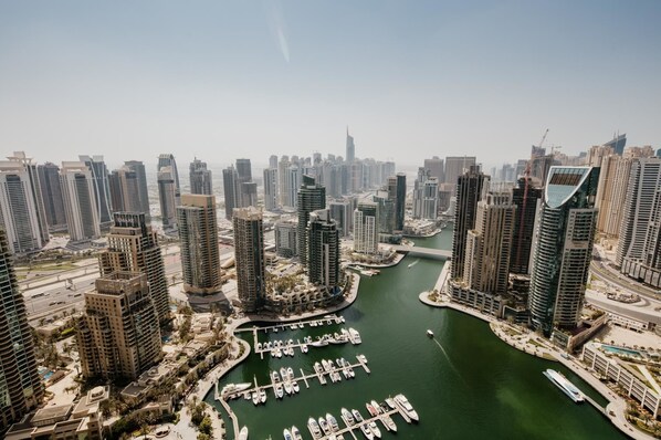 A high-rise urban area with a marina filled with boats.