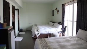 Habitación de hotel con dos camas, un escritorio y una silla.