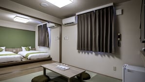A hotel room with two beds, a small table with tea set, air conditioning units, and a refrigerator. - Hotel Lantana Naha matsuyama (Naha)