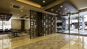 A spacious lobby with a polished floor, seating area, and a view through large glass doors. - Hotel Lantana Naha matsuyama (Naha)