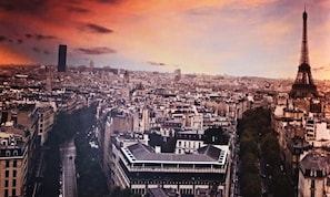 A cityscape with the Eiffel Tower, a large modern building, and a dense urban environment. - ThassCities Casa Studios (Thasos)