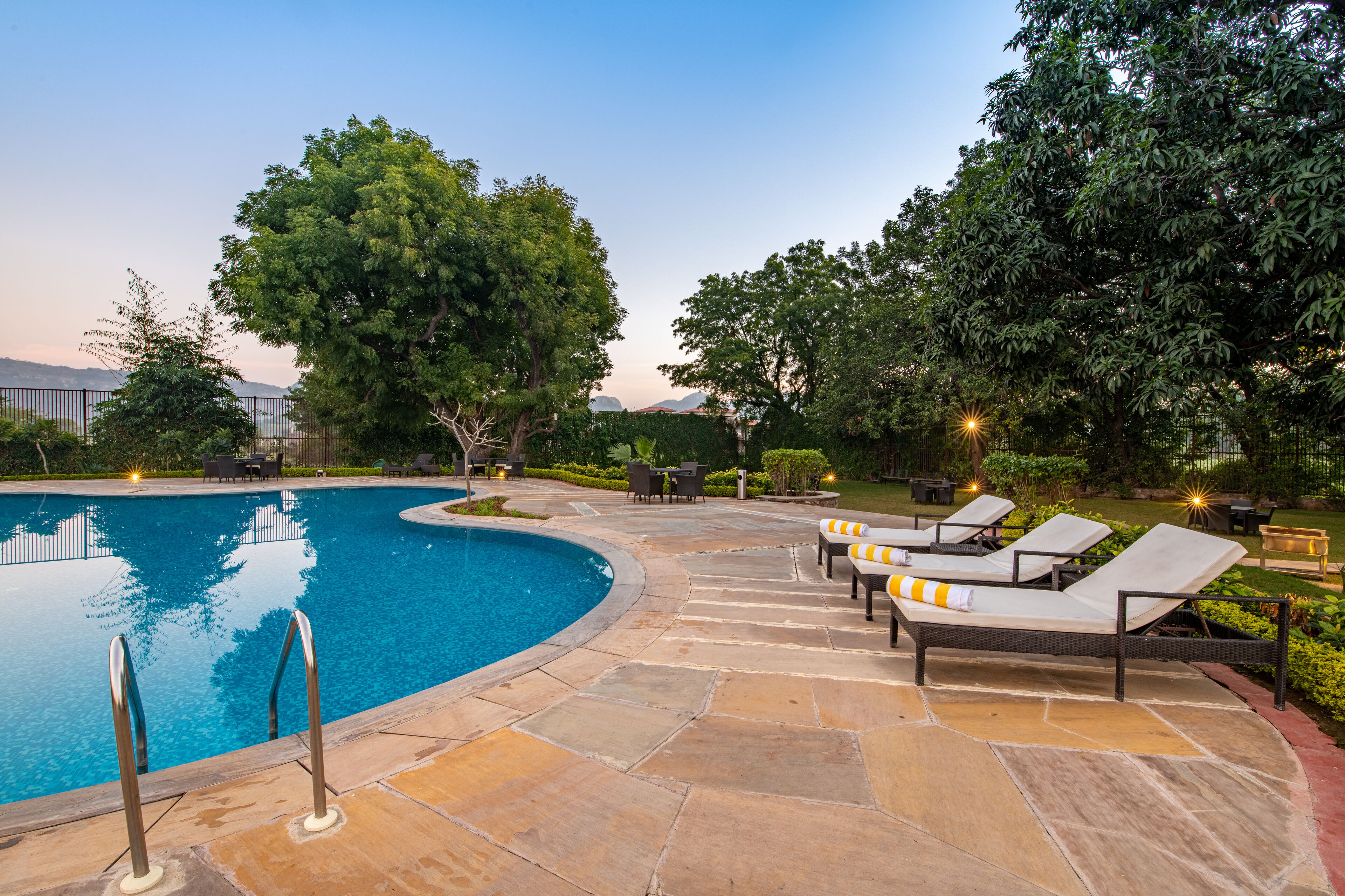 Outdoor pool, open 7:00 AM to 7:00 PM, pool umbrellas, pool loungers