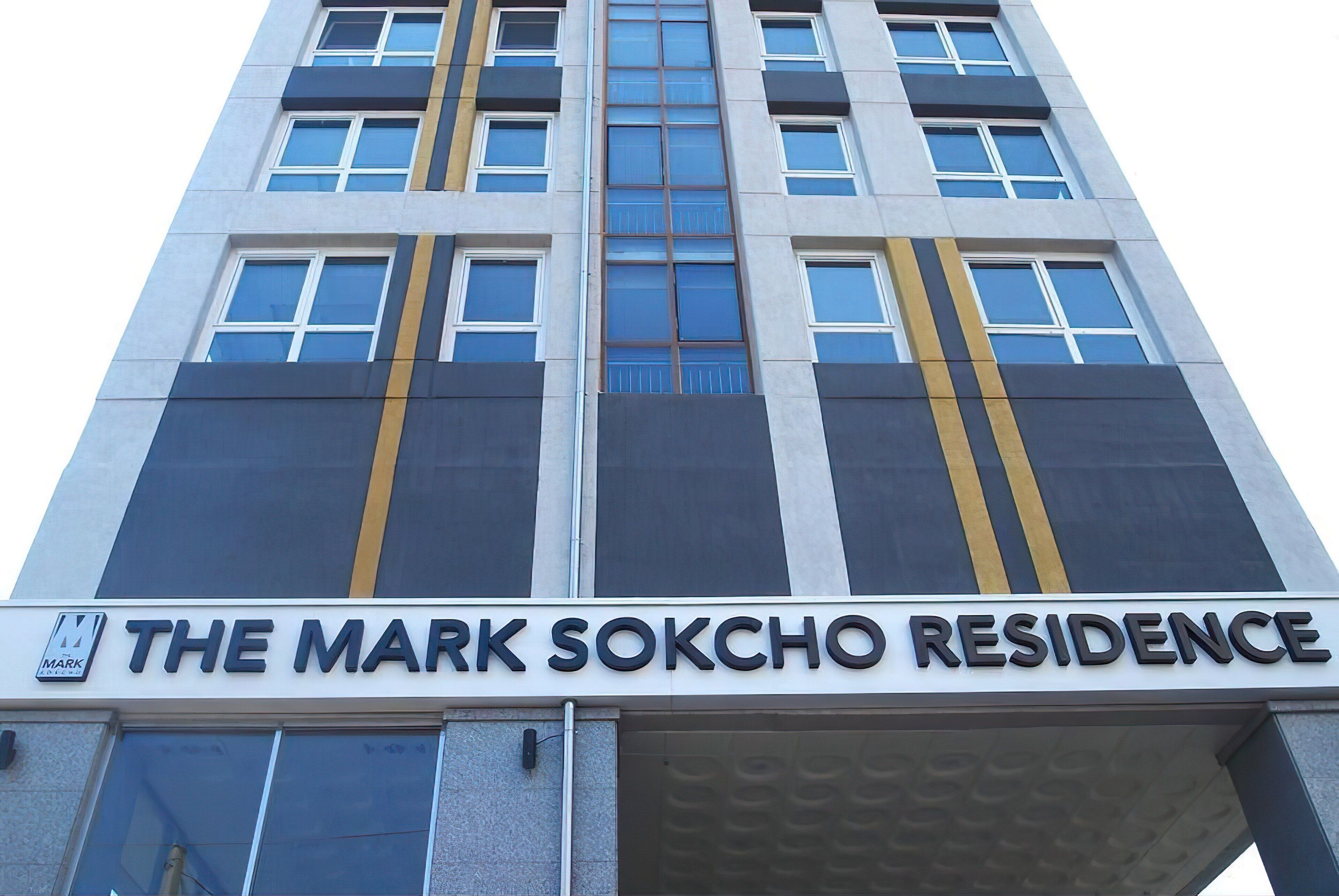 A building with a sign reading "The Mark Soko Residence."