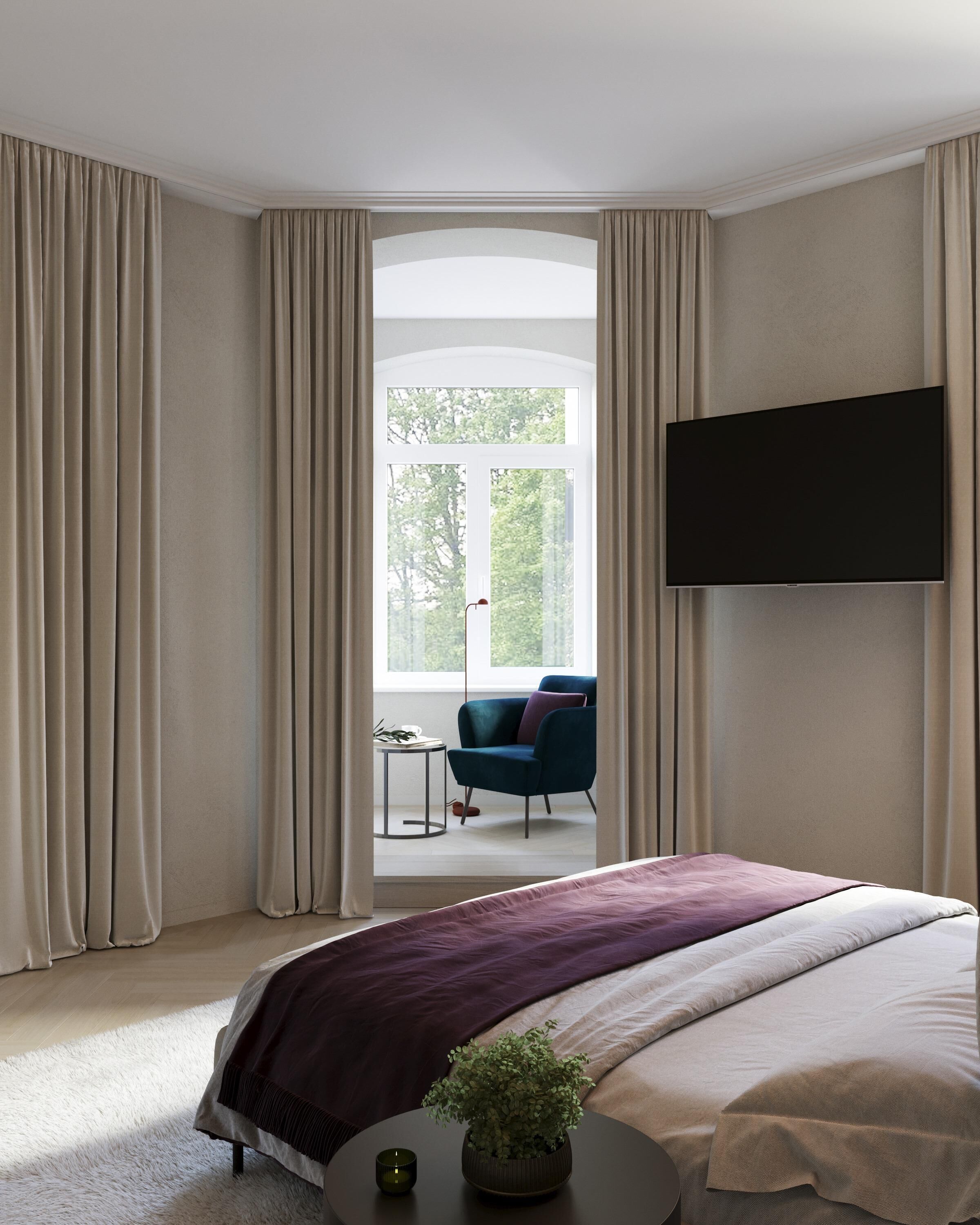 A bedroom with a bed, a TV, a chair, and a window with curtains.