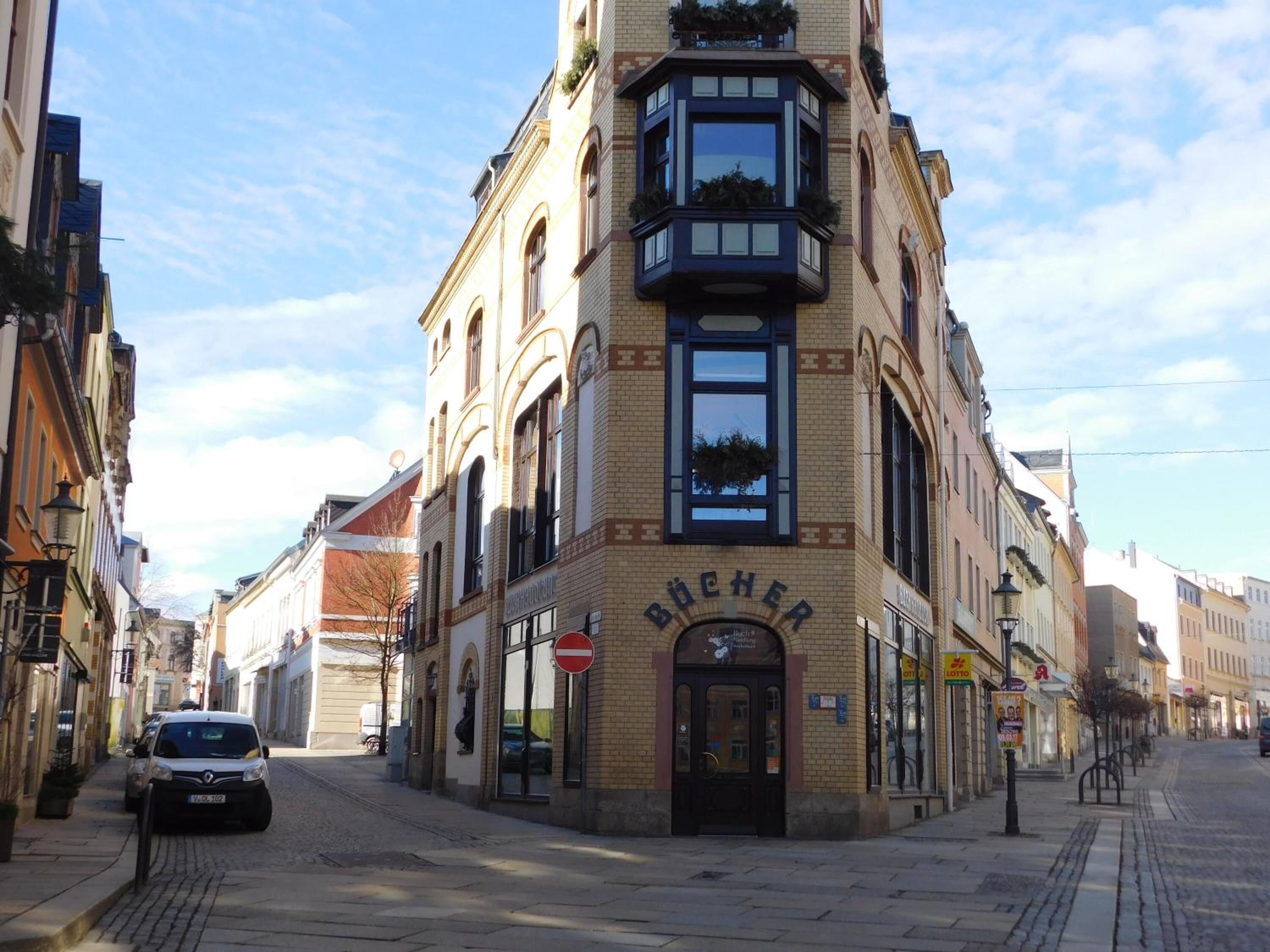 A corner building with a sign reading "BÜCHER".