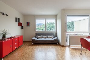 Family Apartment | Living area | 32-inch flat-screen TV with digital channels, TV - Pazzallo Apartments (Lugano)