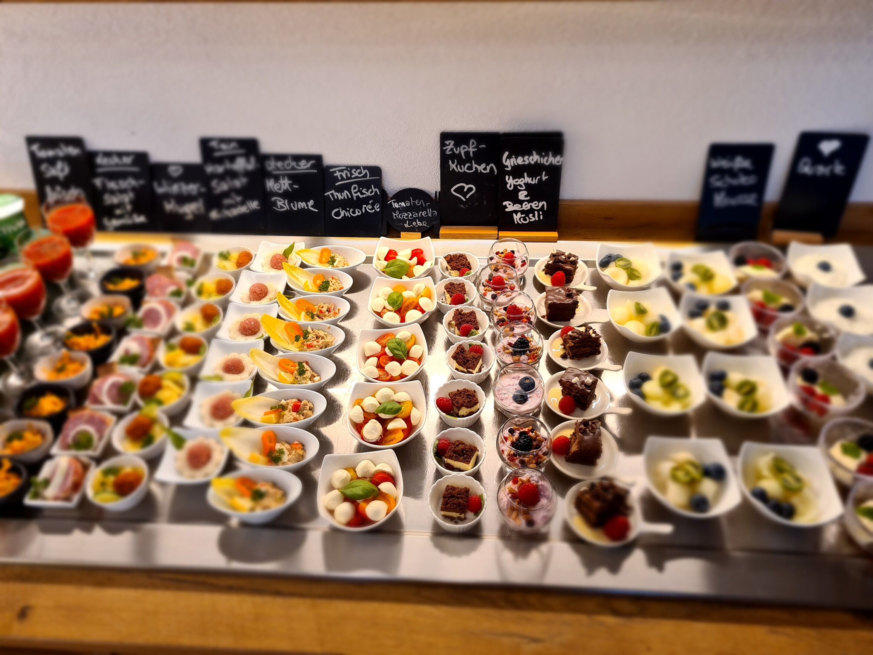 A variety of food items displayed on a tray with labels indicating different types of dishes.