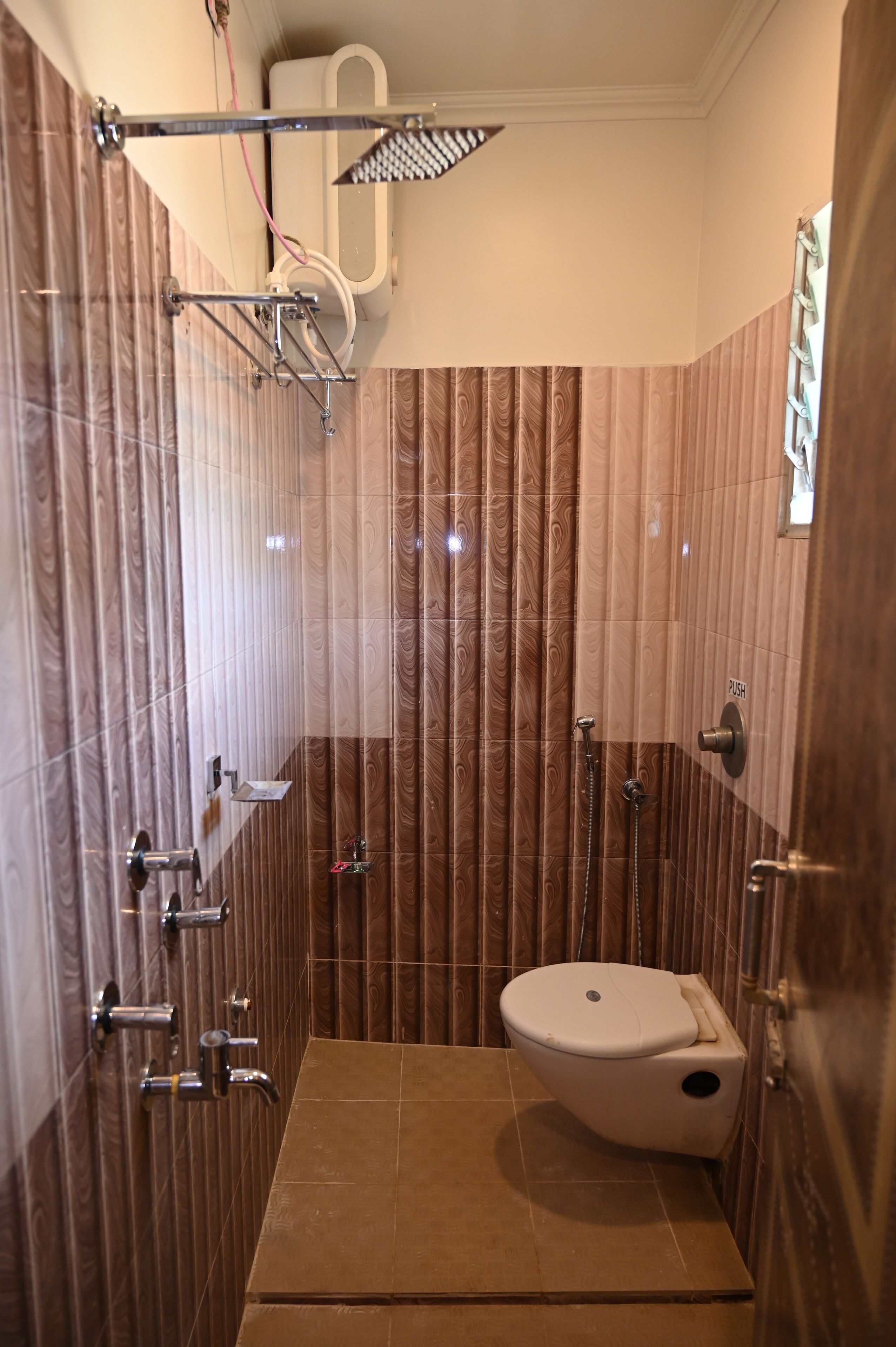 A bathroom with a shower, toilet, and vanity.