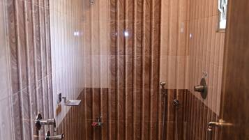 A bathroom with a shower, toilet, and vanity.