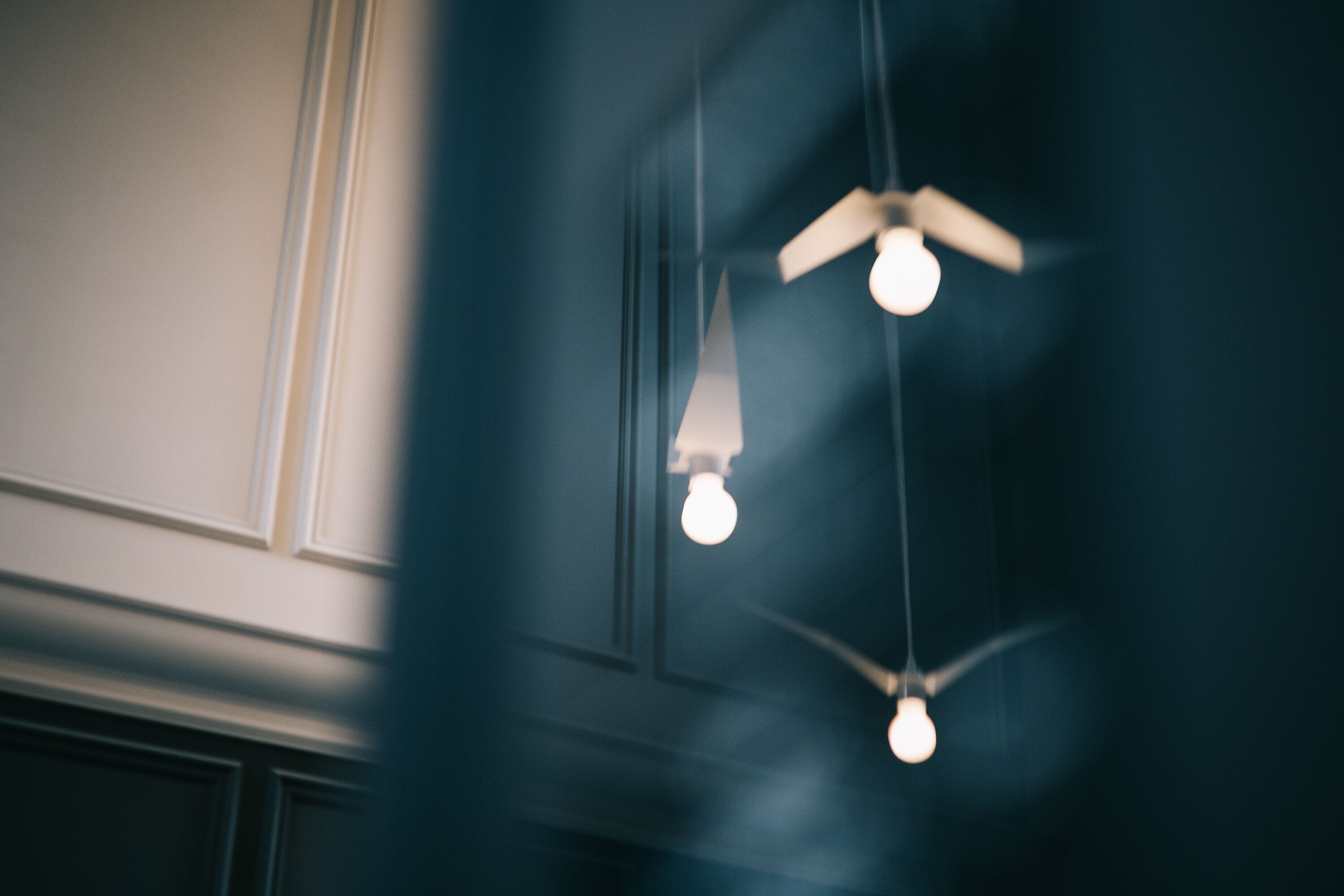 A ceiling fan with three light bulbs.