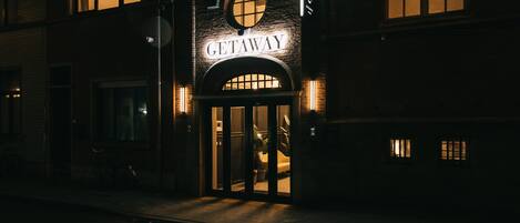A building with a sign reading "GETAWAY" and a circular window above the entrance.