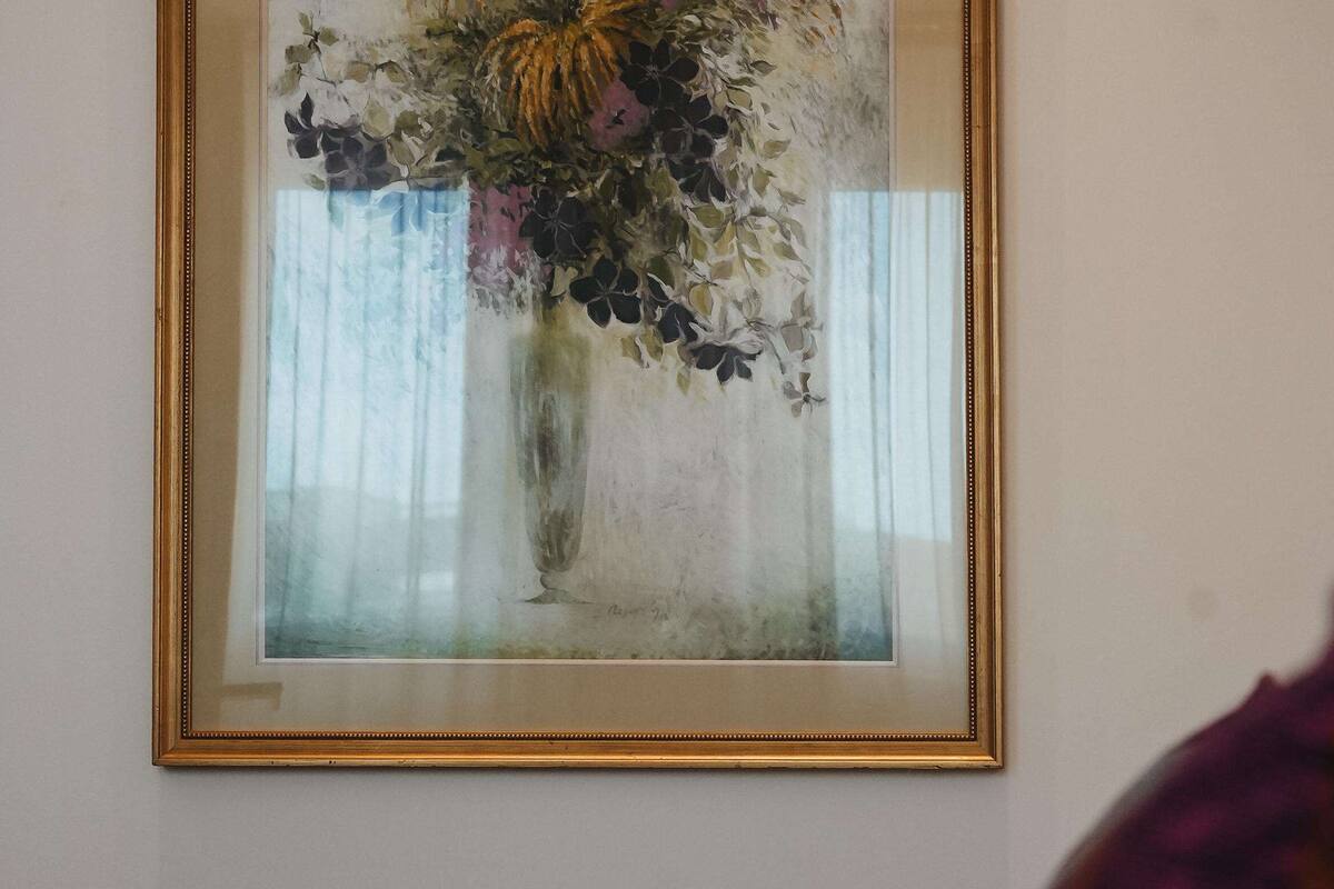 A framed floral artwork on a wall.