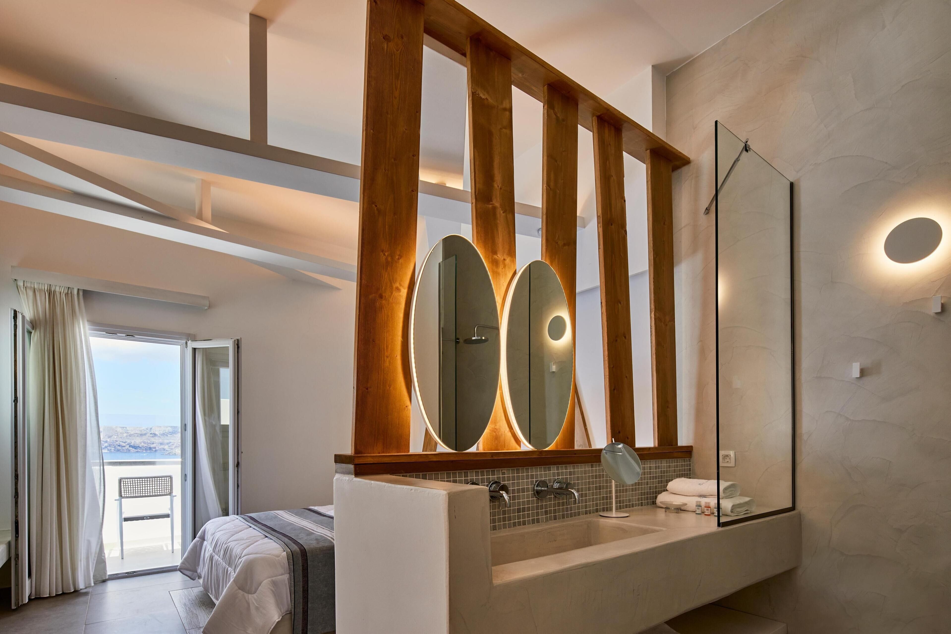 A modern bathroom with a large mirror, a bathtub, and a shower.