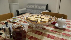Ein Tisch mit Kuchen, Tasse und Marmeladenglas.