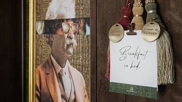 A framed portrait with a caption, a thumbs-up ornament, and a bottle of Brando wine.