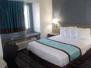 Relax in this inviting room with a comfortable bed, desk, and wall-mounted lamp.