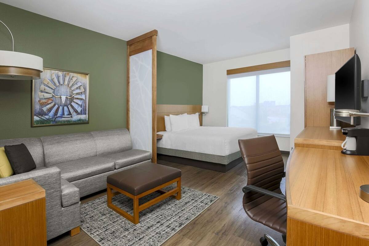 Premium bedding, desk, laptop workspace, blackout drapes
